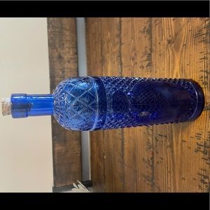 Tall decorative blue glass bottle.